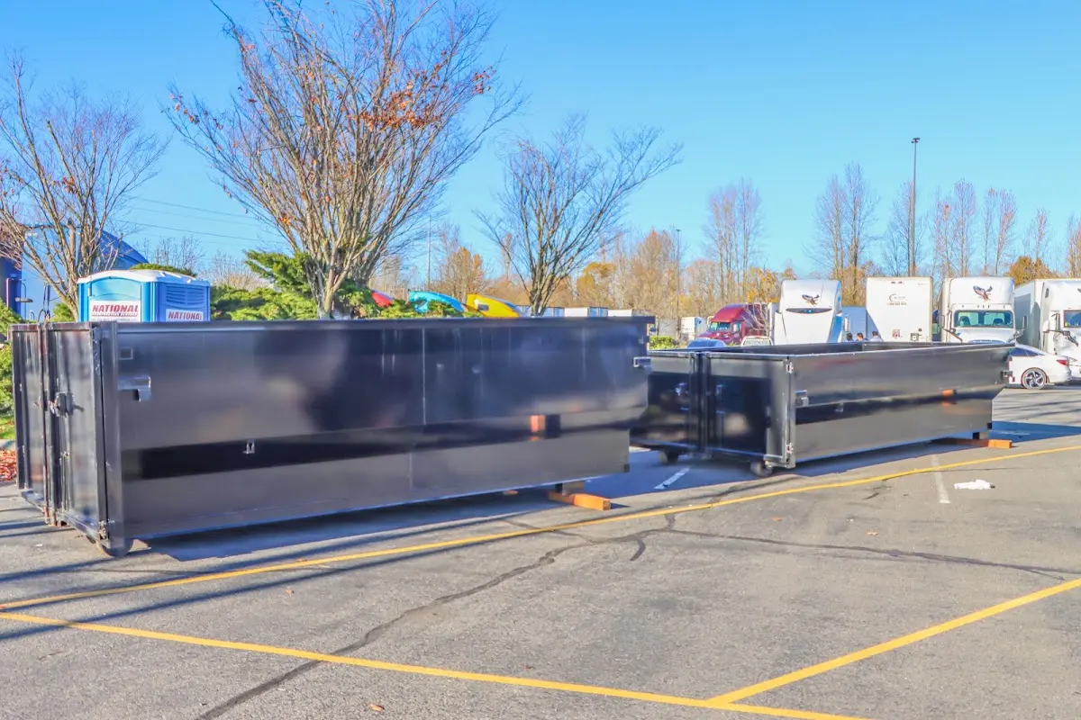 Professional dumpster rental service with roll-off container on residential driveway in Barbecue